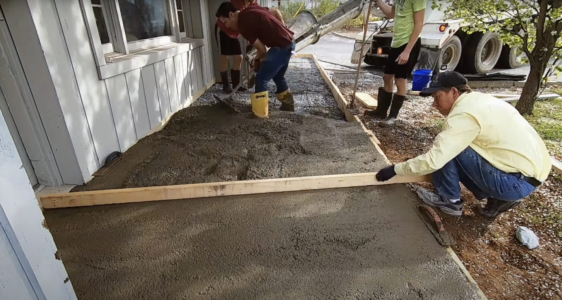 Gary Concrete - Professional concrete sidewalk installation in progress Professional concrete team installing residential sidewalk with proper forming and equipment