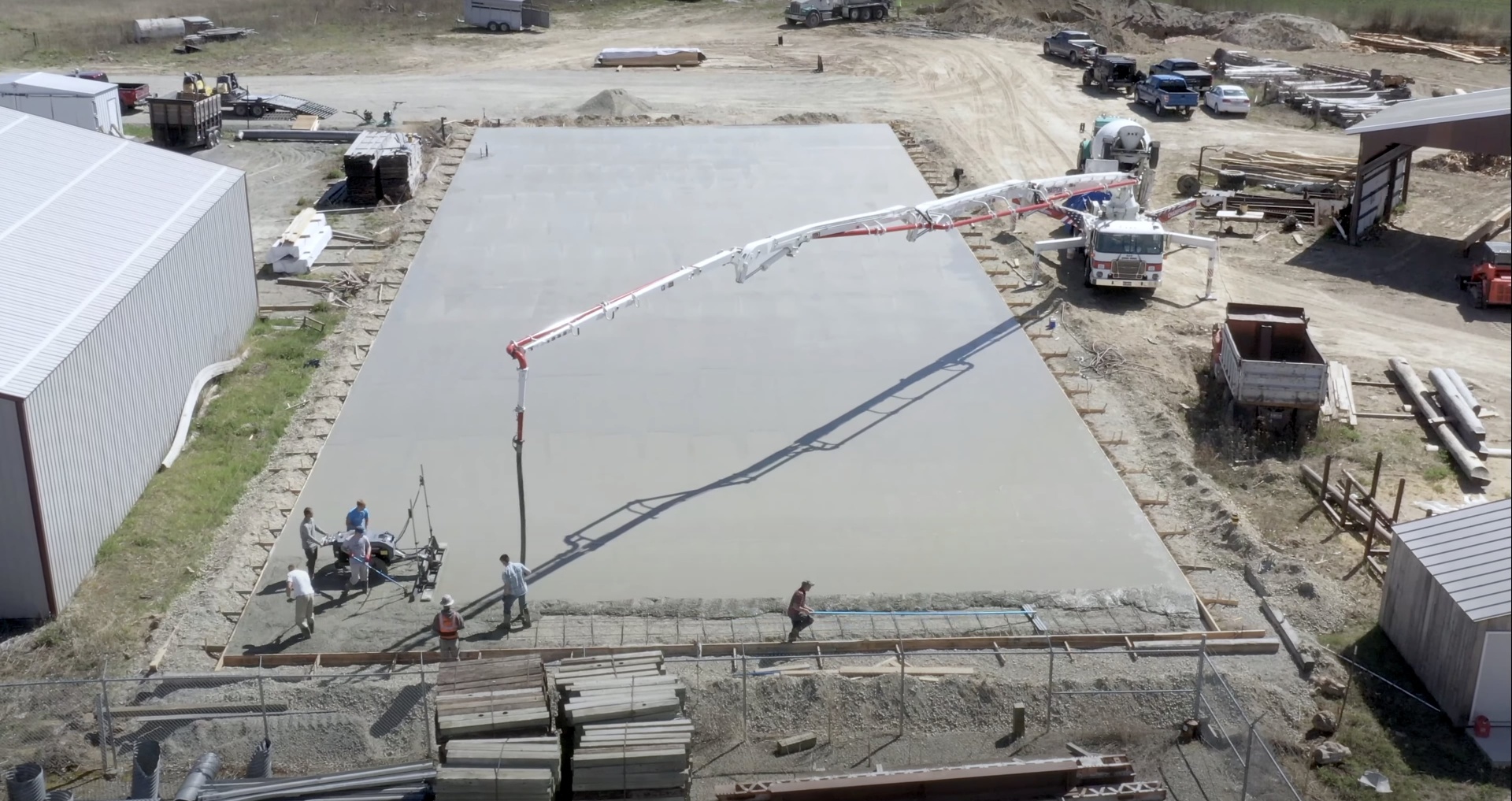 Gary Concrete - Large commercial concrete project with professional equipment Large-scale commercial concrete pour with professional equipment and aerial view