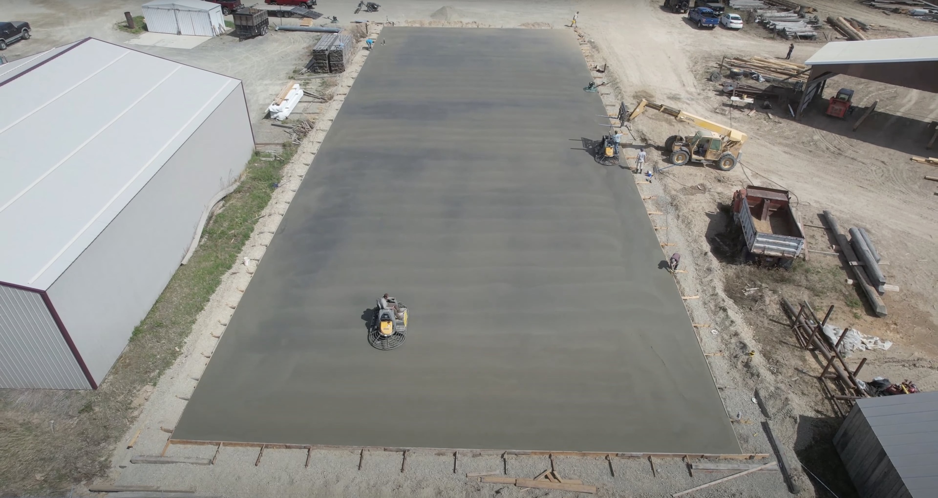 Gary Concrete - Large-scale commercial concrete installation with professional equipment Large-scale commercial concrete pour aerial view showing professional equipment and team