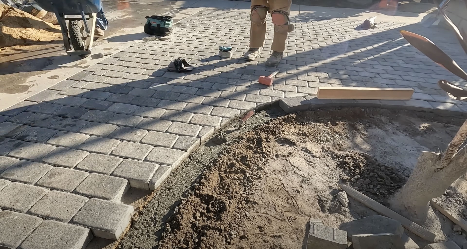 Gary Concrete - Professional concrete paver installation by skilled team Professional concrete paver installation in progress with skilled craftsmen working